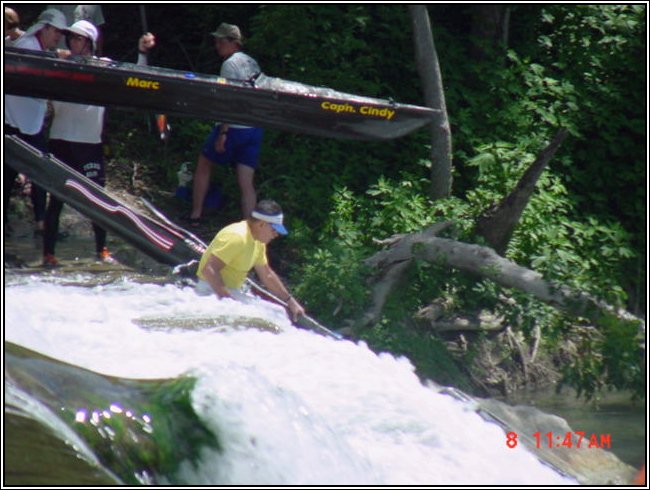 John Bugge taking his boat over Staples Dam