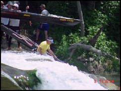 John Bugge taking his boat over Staples Dam
