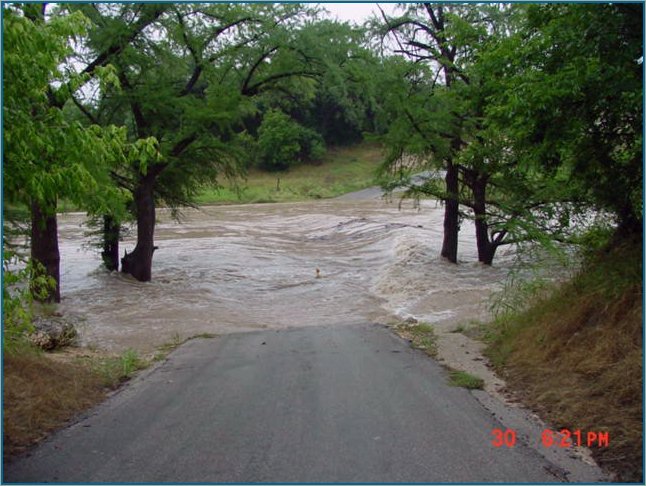 Rebecca Creek Crossing as the floodwaters cover the bridge