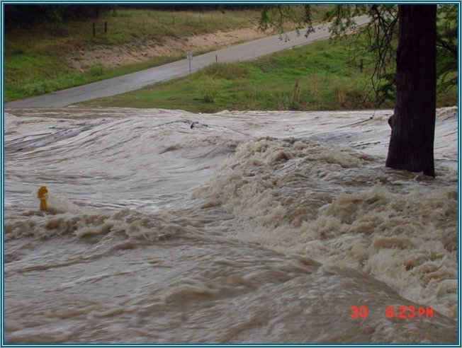 Rebecca Creek Crossing under water with 5-6 foot waves surging toward Canyon Lake